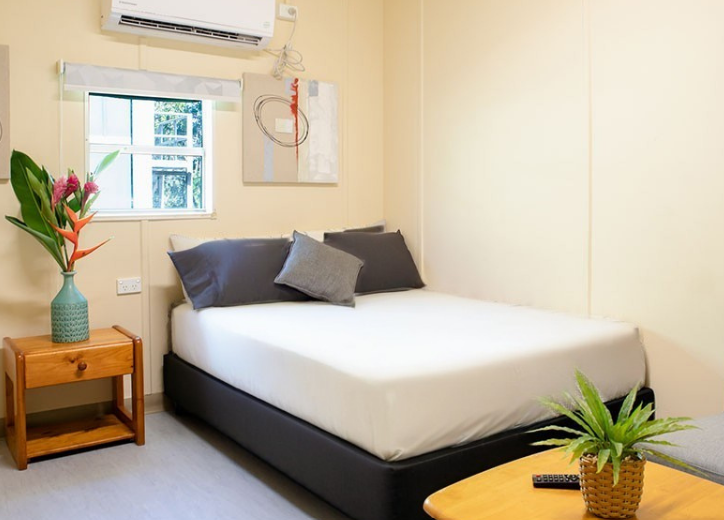 Neat bed with white sheet cover